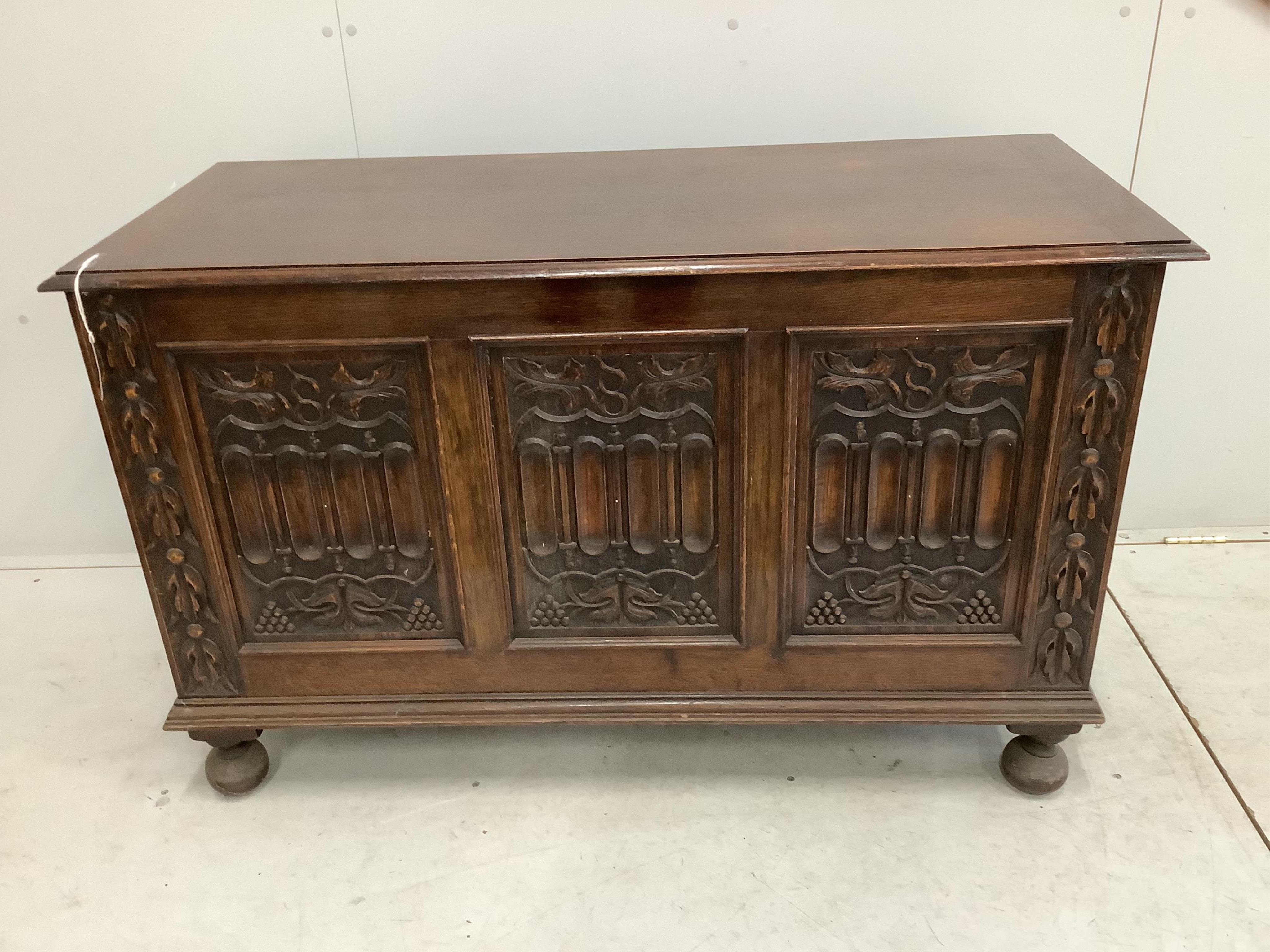 A 17th century style carved oak coffer, width 121cm, depth 52cm, height 76cm. Condition - fair